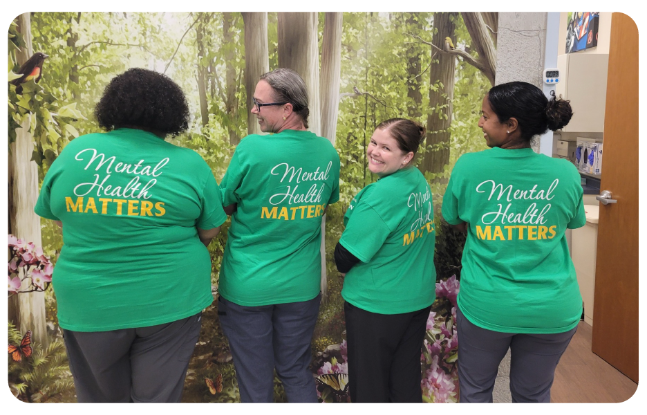 Pm Pediatric Care staff wearing matching green shirts to celebrate mental health awareness